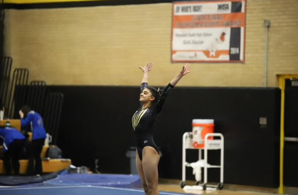 Anya Patel saluting after finishing her floor routine at a Hinsdale South home Meet
