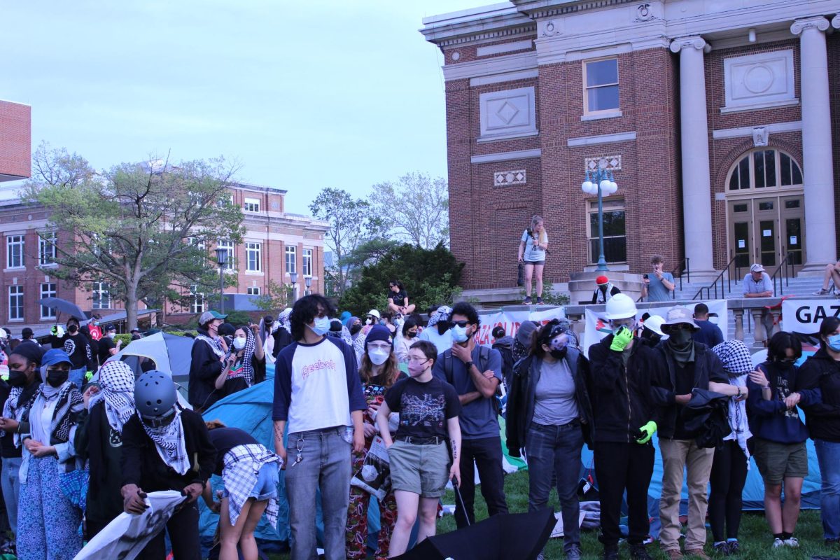 Students stand in a circle to help position themselves in a defense stance in case they were to be broken up by police.