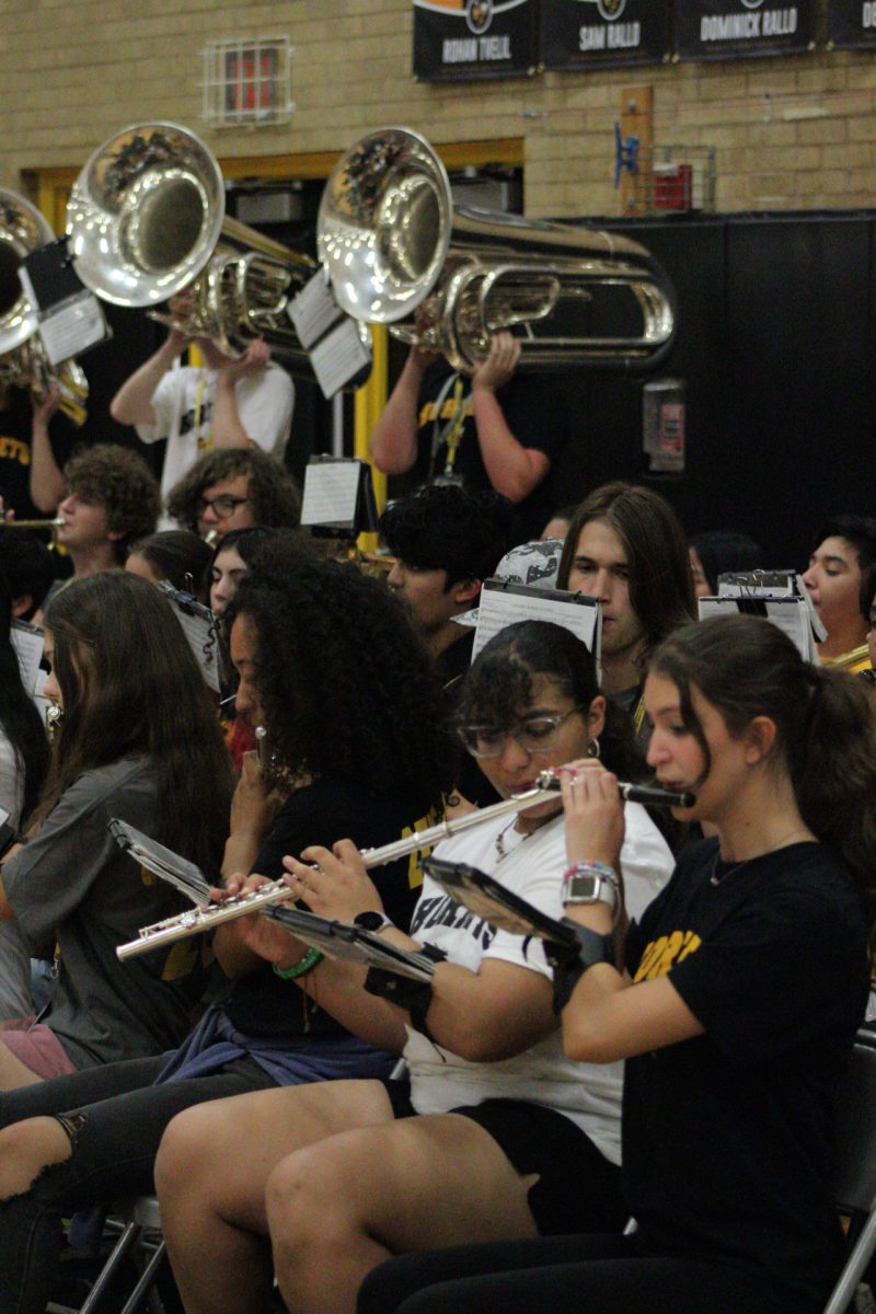 Band members playing music for the audience of the assembly.