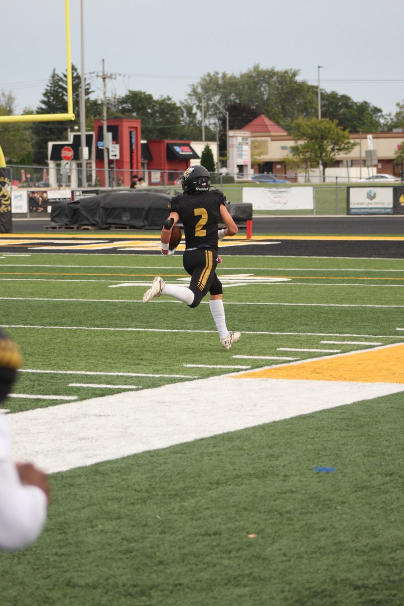 Brady Miller, rushing towards the endzone scoring a point for Hinsdale South and helping the morale of the team against Willowbrook High School