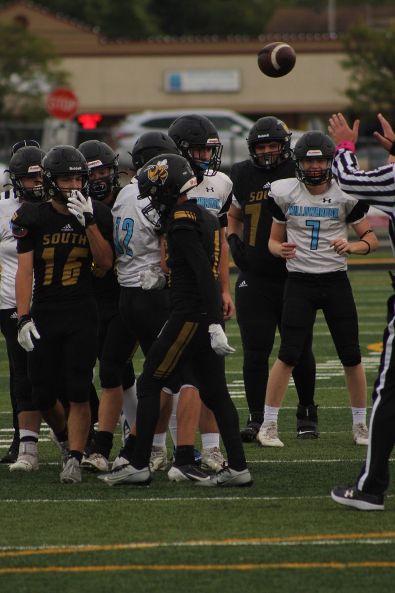 As a play finishes many members of Hinsdale Souths junior varsity football team congregate and talk to each other to better coordinate themselves.