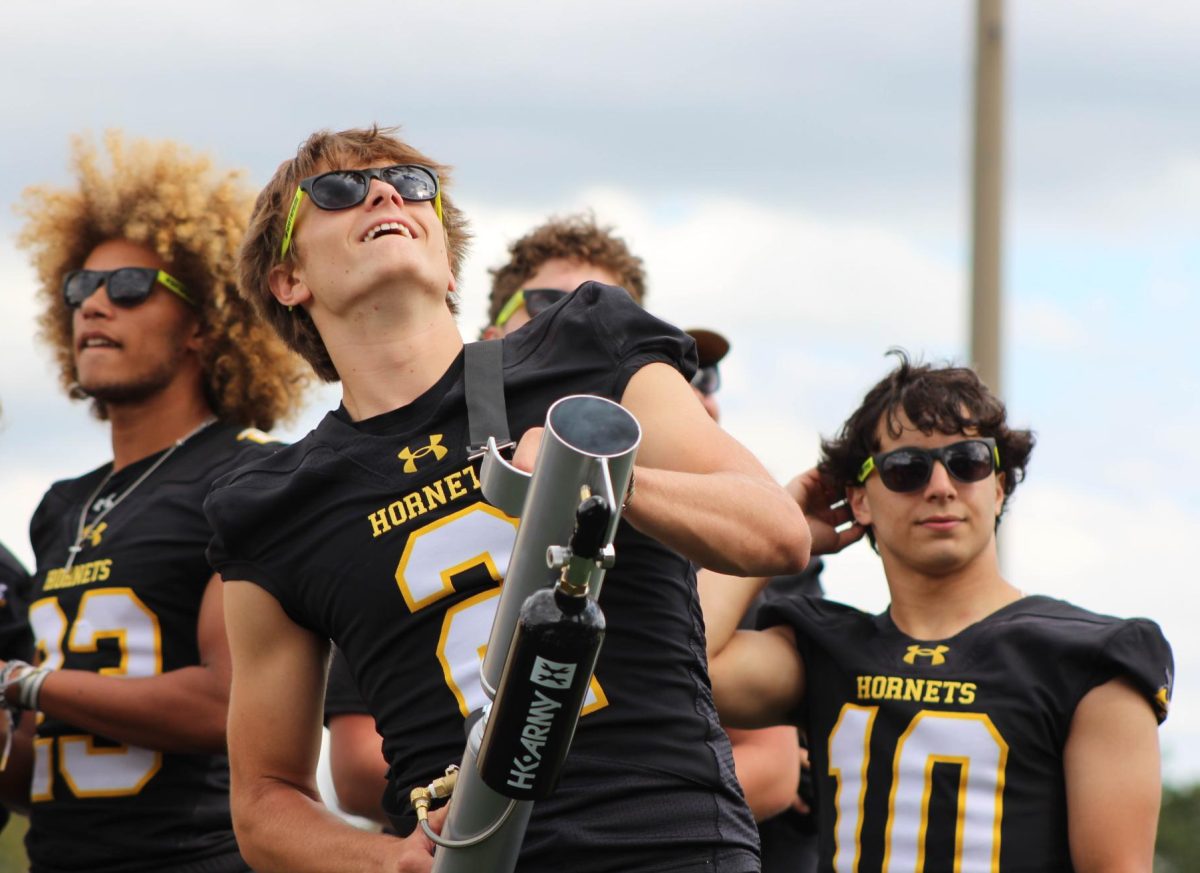 Varsity football players Daxton Michaels, along with other players such as Ayden Farrare and Al Amir Alamani operate the t-shirt launcher, making the crowd participate in the event.