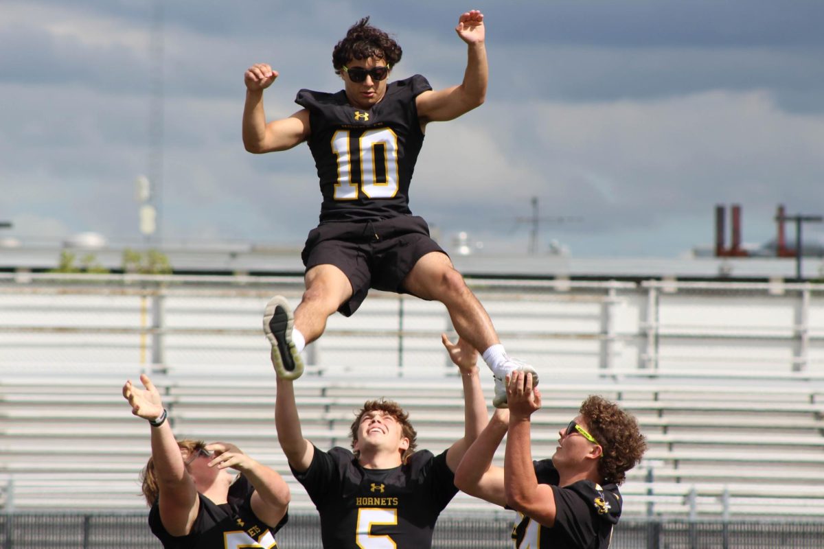 The varsity football team performing a stunt to help elevate the mood.