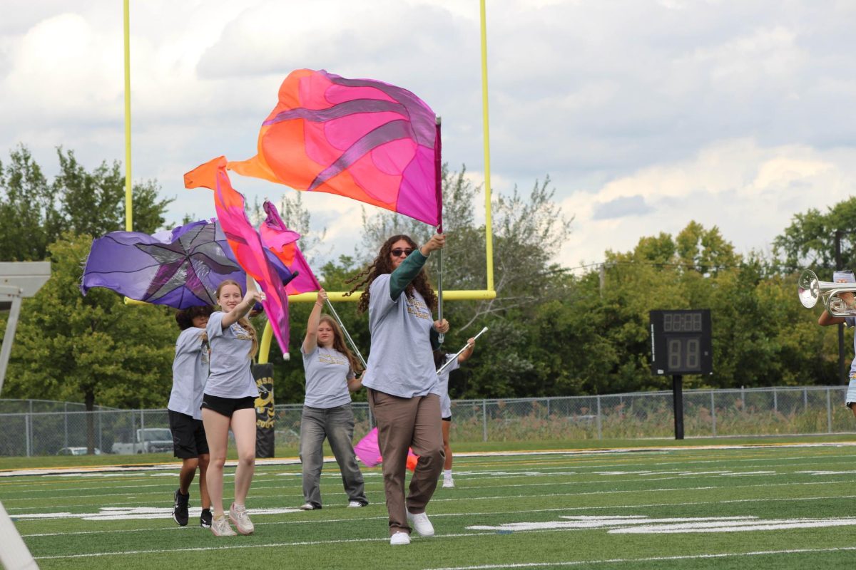 The color guard marching helping the show of school pride.