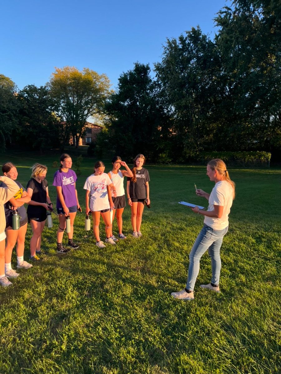 Ms. Johnson coaching the girls cross country team after a run