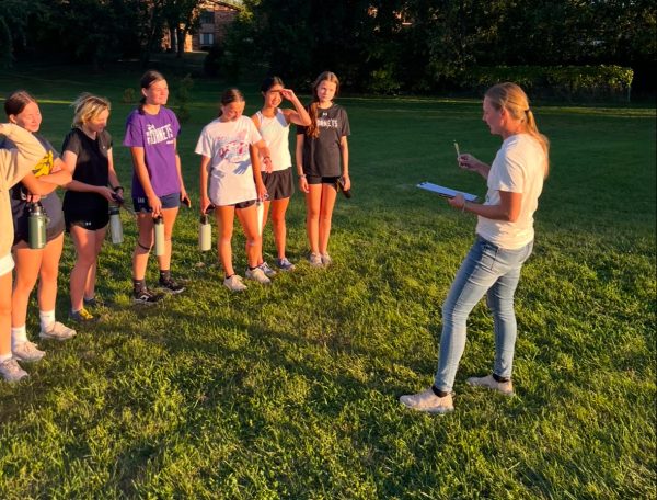 Ms. Johnson coaching the girls cross country team after a run