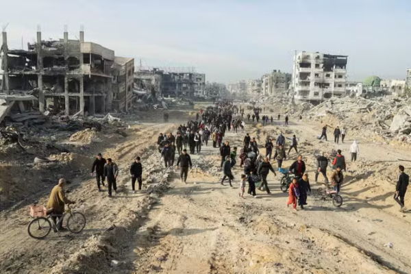 People return to their homes in Gaza City, Gaza Strip, Thursday, Jan. 30, 2025, after a ceasefire. The truce allows displaced families to assess damage.