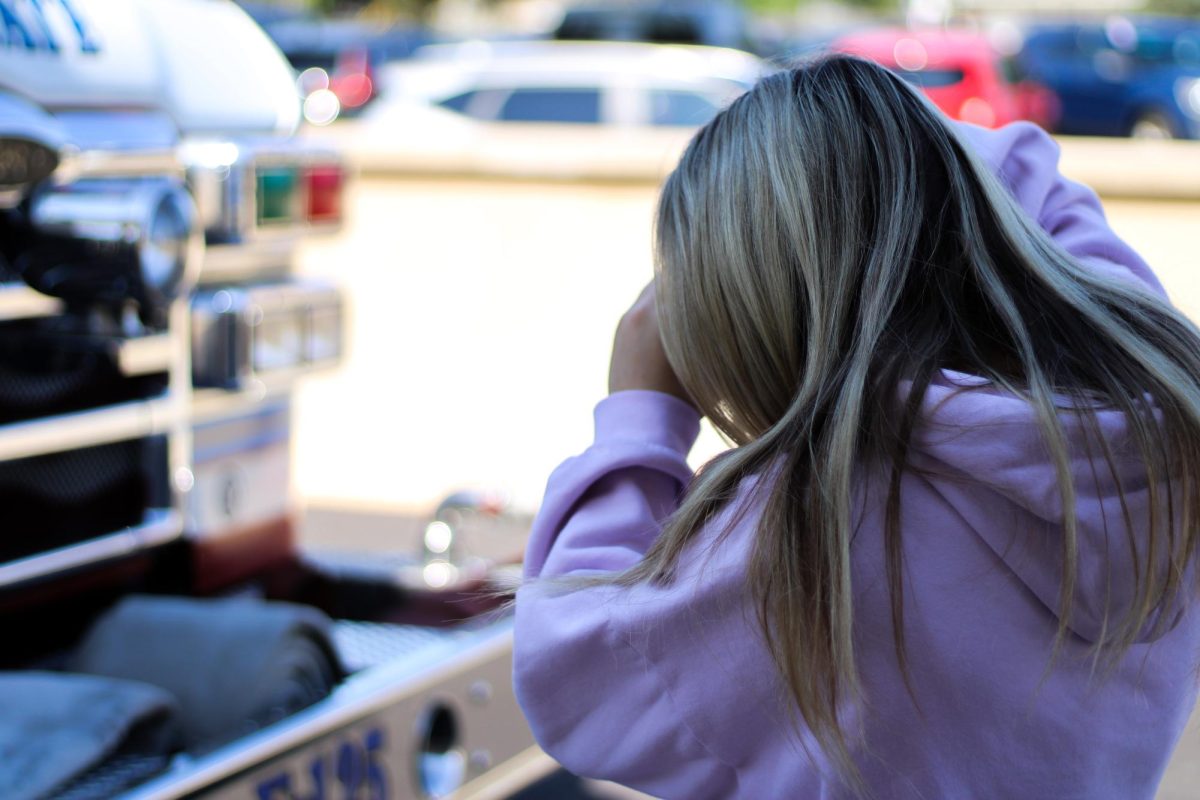 (Senior) Callie Carr as she takes photos of the firetruck for an assignment while out for the event, September 18th 2025