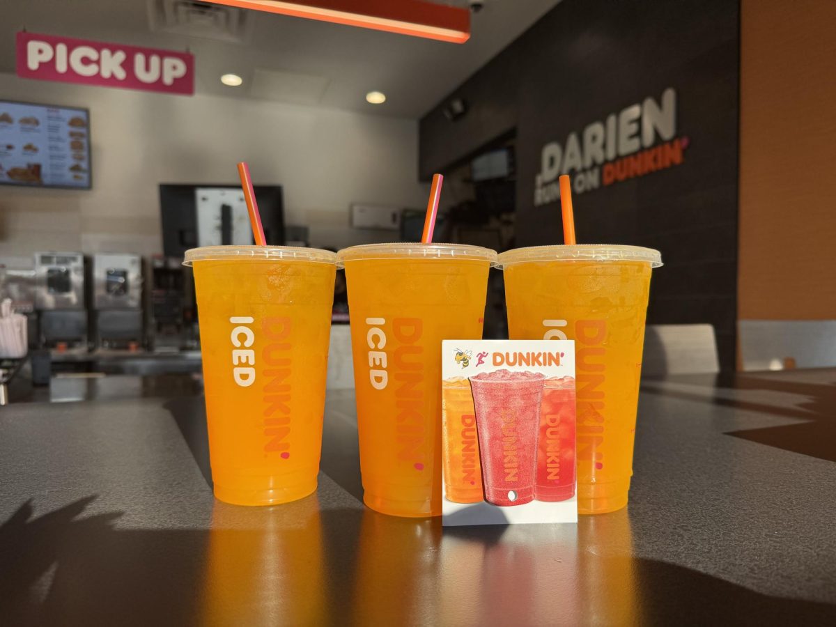 Photo of ¨Dunkin Refresher¨ with Dunkin Refresher gift card in front.