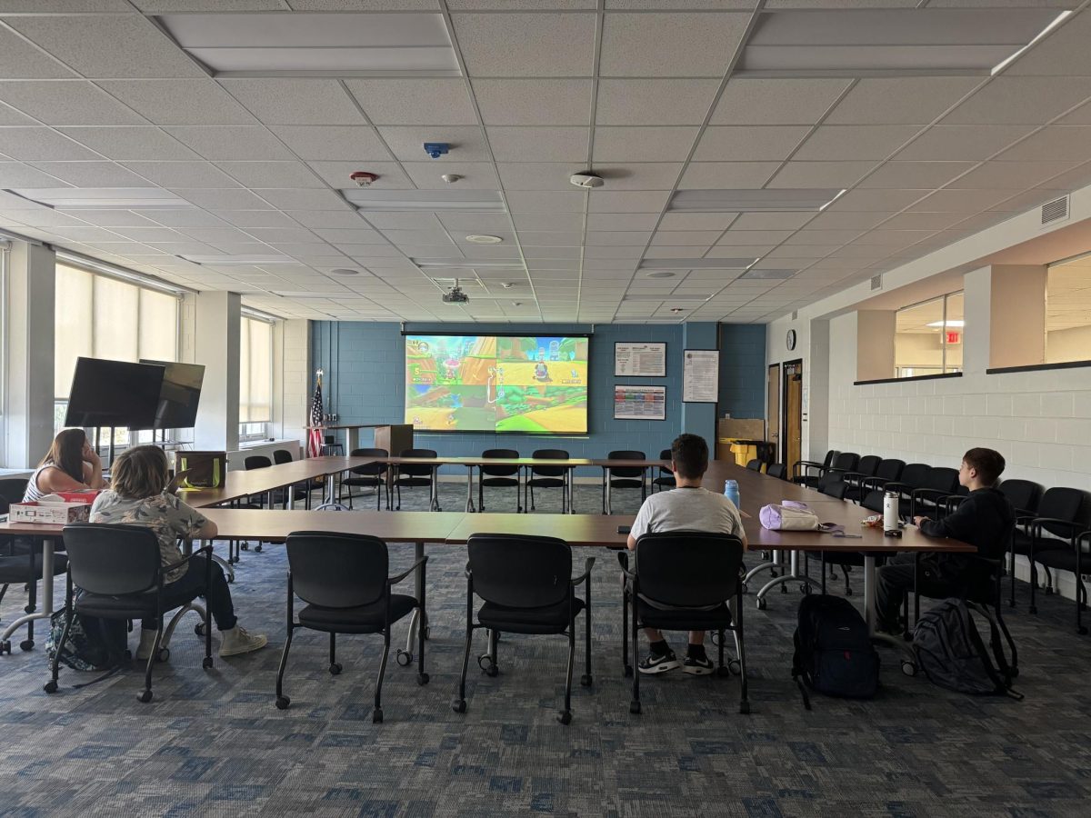 Students enjoy playing video games at e-sports club. 